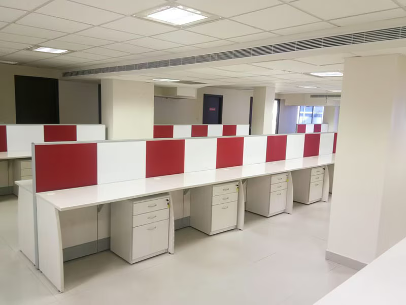 A modular office workstation cluster manufactured by Sri Ranga Interior, with screened partitions and integrated cable management